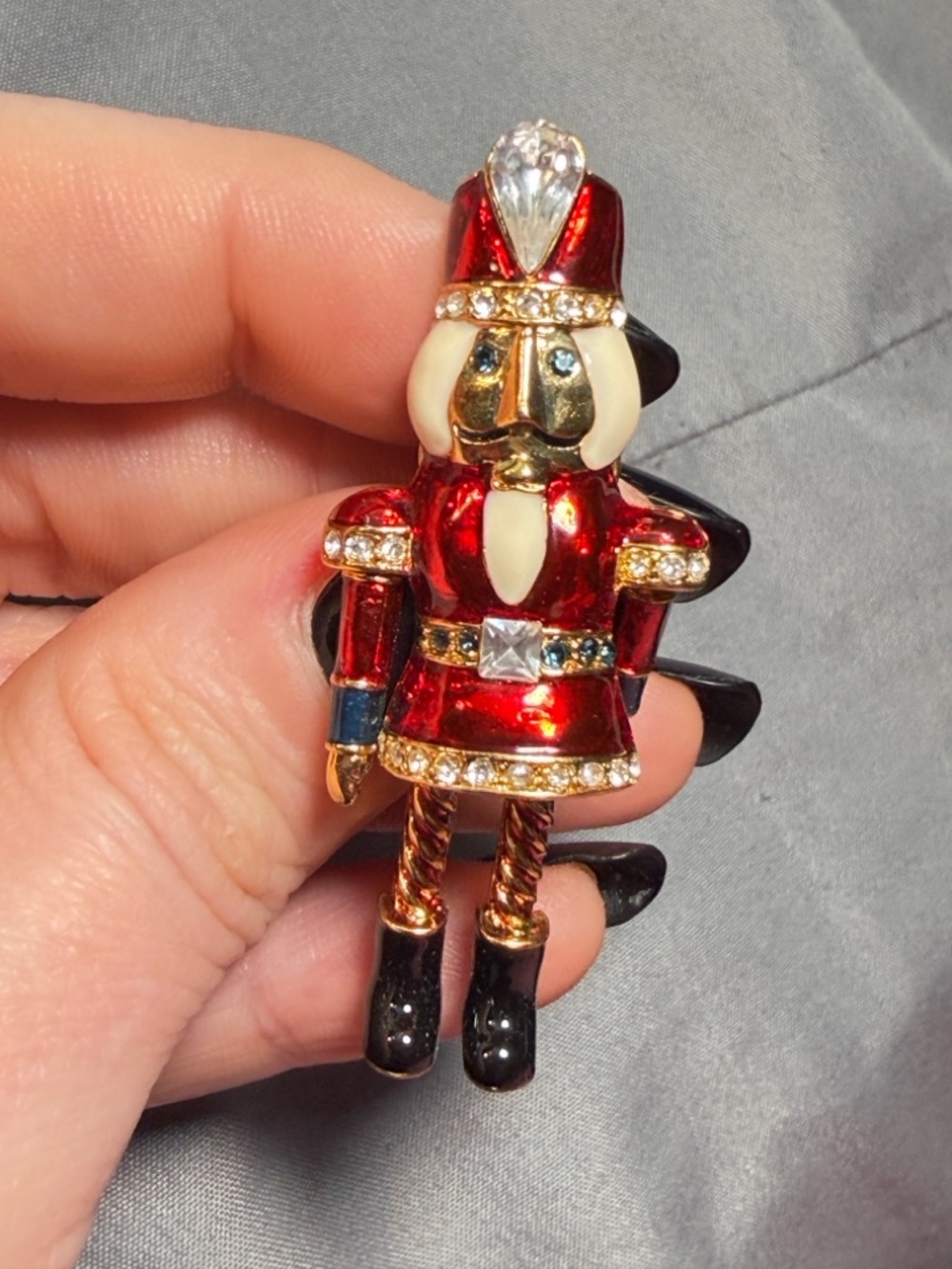 Avon Nutcracker Brooch Vintage Red Rhinestone Dangle Legs Holiday Pin 2.2”